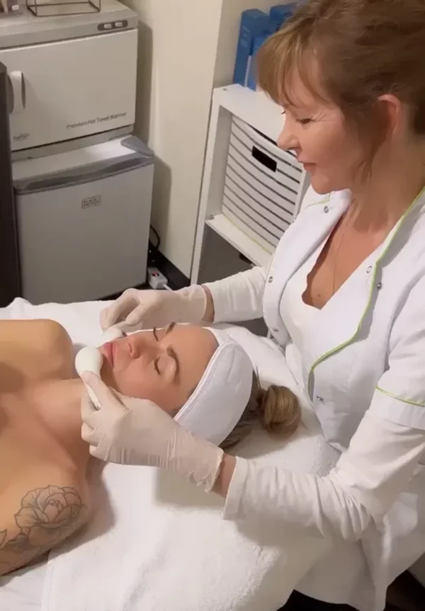 An esthetician performing a facial treatment at Organic Spa Chicago