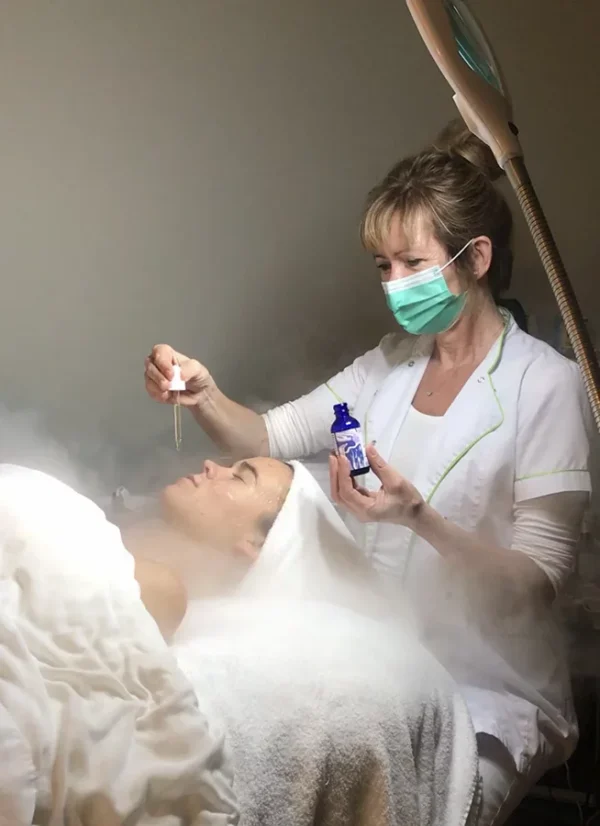 Applying a treatment serum during a steam facial